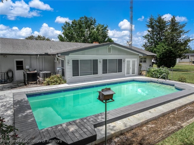 302 S Egret St, Sebring, FL 33870 - swimming pool with french doors, fence, and central AC