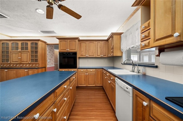 302 S Egret St, Sebring, FL 33870 - kitchen featuring black appliances, a sink, a textured ceiling, wood finished floors, and a ceiling fan