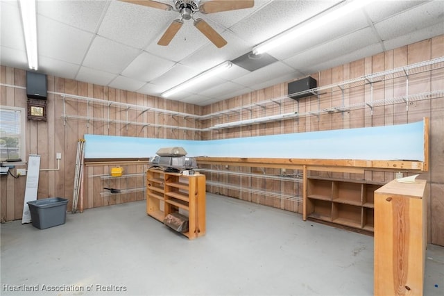 302 S Egret St, Sebring, FL 33870 - miscellaneous room featuring a drop ceiling, finished concrete flooring, a ceiling fan, and wood walls