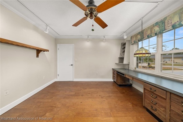 302 S Egret St, Sebring, FL 33870 - unfurnished office with track lighting, ceiling fan, built in desk, baseboards, and crown molding