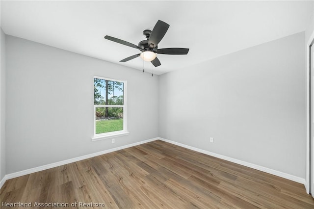 spare room with ceiling fan and hardwood / wood-style flooring