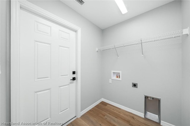 clothes washing area featuring hardwood / wood-style flooring, hookup for a washing machine, and hookup for an electric dryer