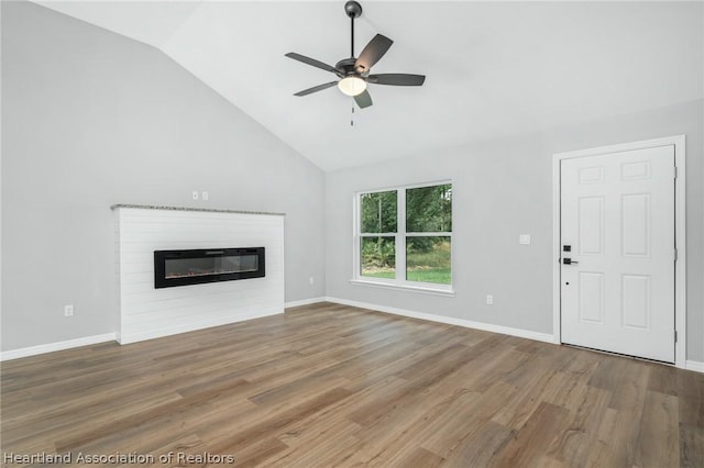 unfurnished living room featuring ceiling fan, wood-type flooring, and vaulted ceiling