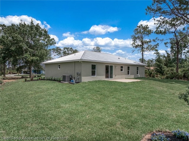 back of property featuring a patio, central AC, and a lawn