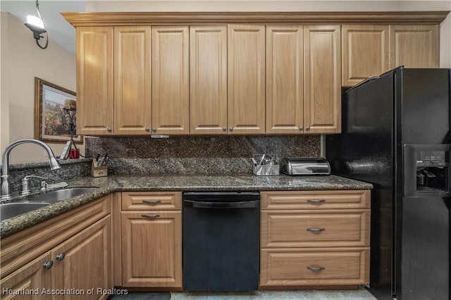 kitchen featuring dark stone counters, sink, decorative backsplash, and black appliances