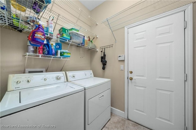 laundry room with separate washer and dryer and light tile patterned floors