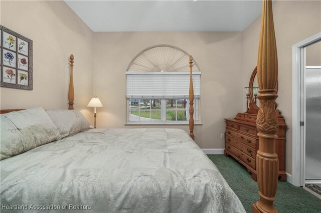 bedroom featuring dark carpet, ceiling fan, and a closet