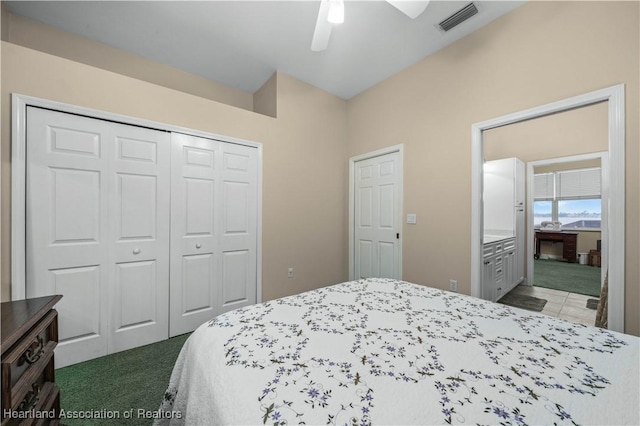 carpeted bedroom featuring ceiling fan and a closet