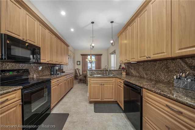 kitchen featuring sink, hanging light fixtures, dark stone counters, decorative backsplash, and black appliances