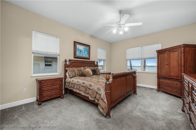 bedroom with ceiling fan and light carpet