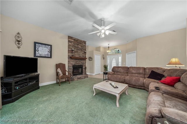 living room featuring a stone fireplace, ceiling fan, and carpet flooring