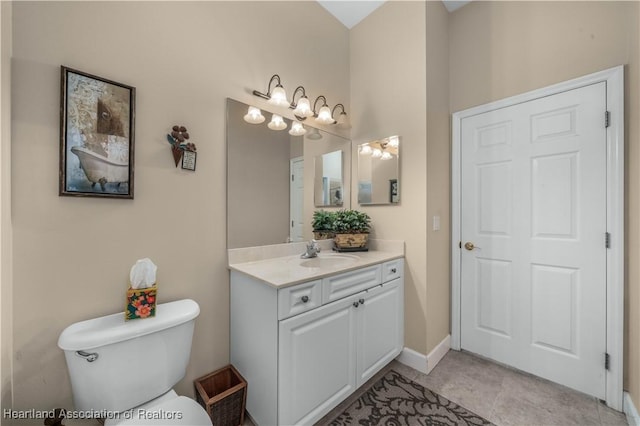 bathroom featuring vanity, tile patterned floors, and toilet