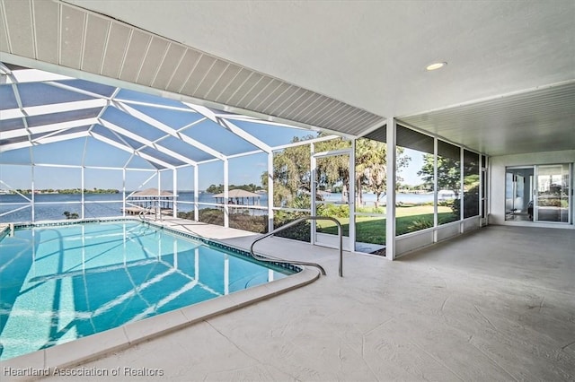 outdoor pool with glass enclosure and a patio area