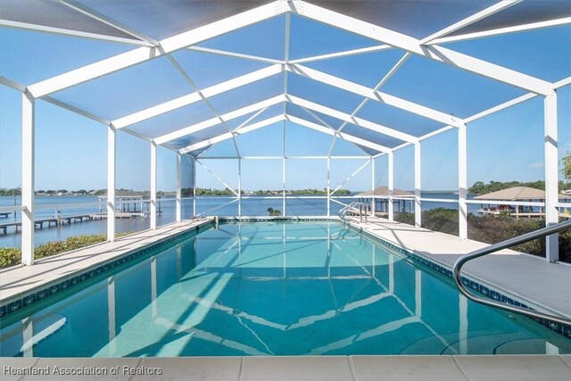 pool featuring a lanai and a water view