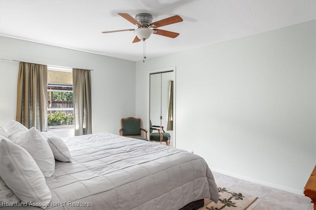 bedroom featuring baseboards, a ceiling fan, and light tile patterned floors