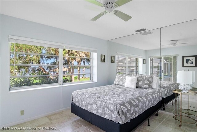 bedroom featuring baseboards, ceiling fan, and visible vents