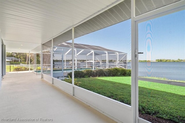 unfurnished sunroom featuring a water view
