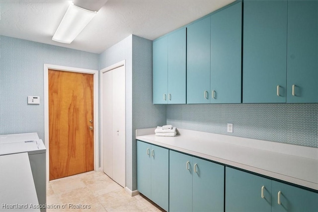 washroom featuring cabinet space and washer / dryer