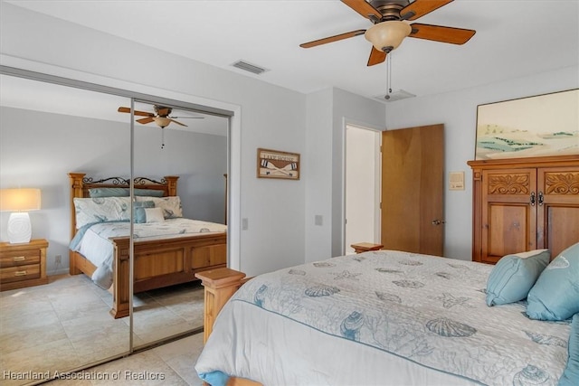 bedroom featuring light tile patterned floors, ceiling fan, and visible vents