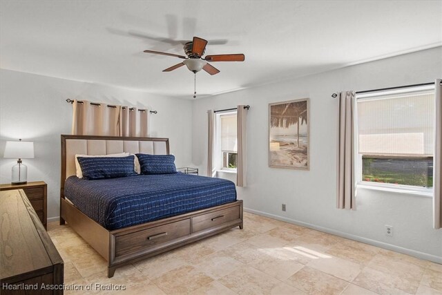 bedroom featuring baseboards and ceiling fan
