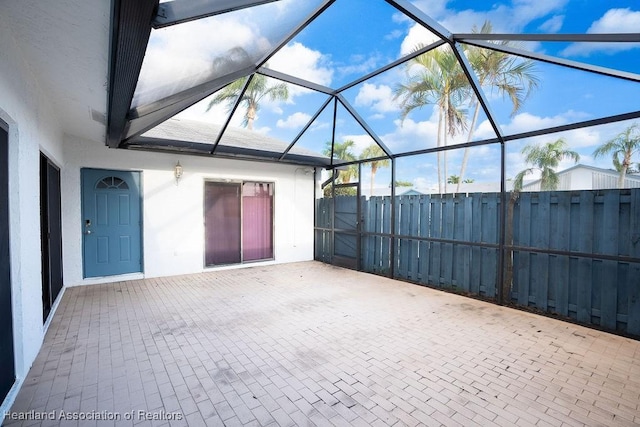 view of patio / terrace featuring glass enclosure