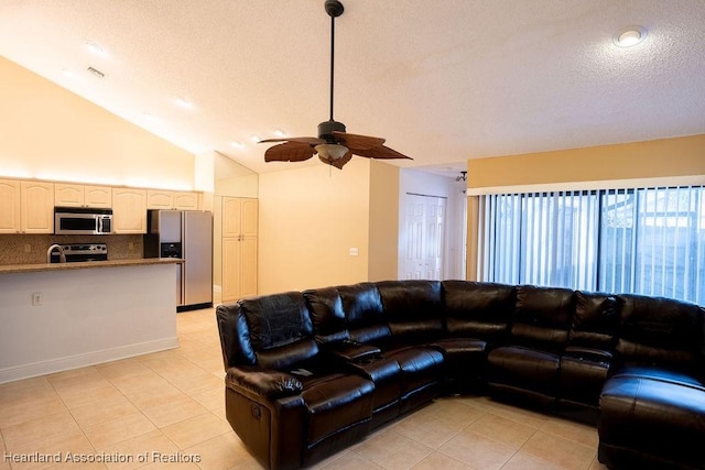 living room with high vaulted ceiling, ceiling fan, and light tile patterned flooring