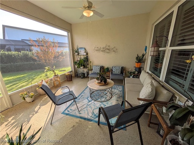 sunroom / solarium featuring ceiling fan