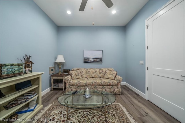 living room featuring hardwood / wood-style flooring and ceiling fan