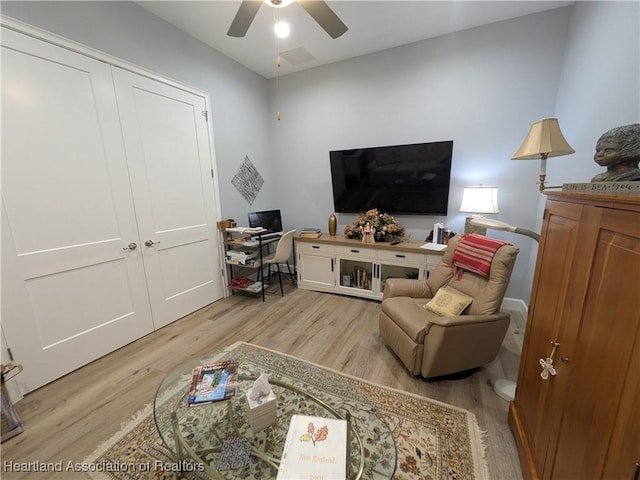 living room with ceiling fan and light hardwood / wood-style floors