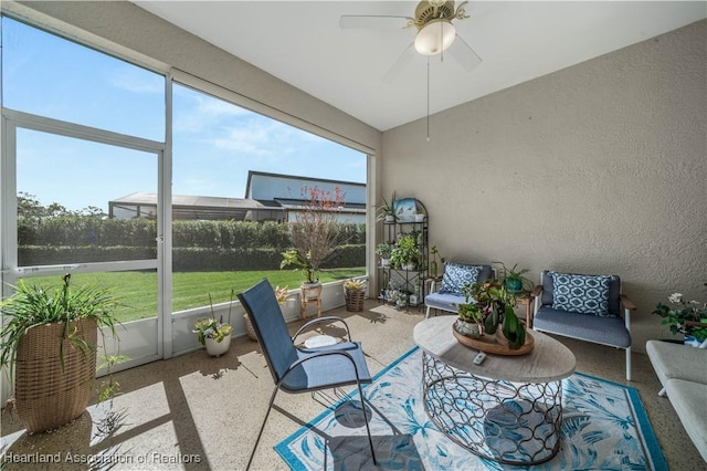 unfurnished sunroom featuring a healthy amount of sunlight and ceiling fan