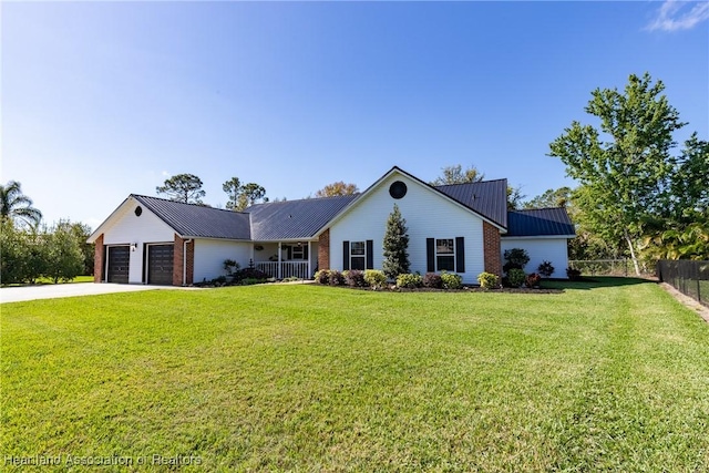 single story home featuring a garage, a front yard, metal roof, and fence