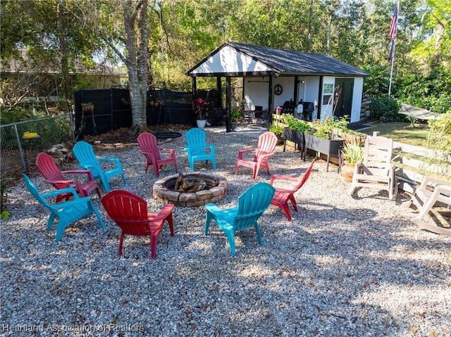 view of yard featuring fence and a fire pit