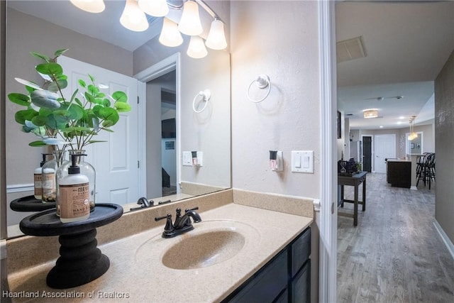 bathroom with vanity and wood finished floors