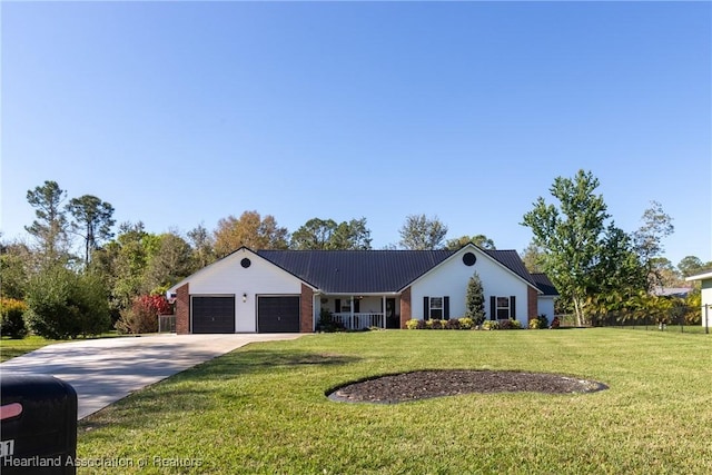 ranch-style home featuring metal roof, a garage, brick siding, concrete driveway, and a front yard