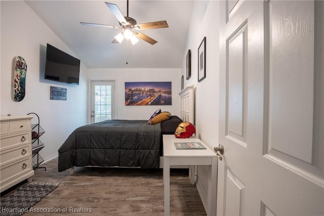 bedroom with a ceiling fan, vaulted ceiling, and wood finished floors