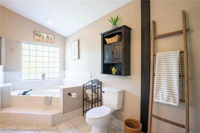 bathroom with toilet, a garden tub, vaulted ceiling, and tile patterned floors