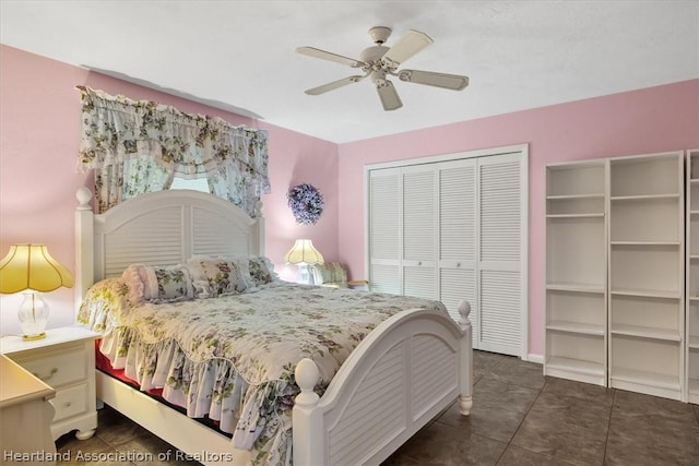 tiled bedroom featuring ceiling fan and a closet