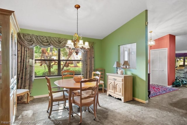 tiled dining space featuring lofted ceiling and a notable chandelier