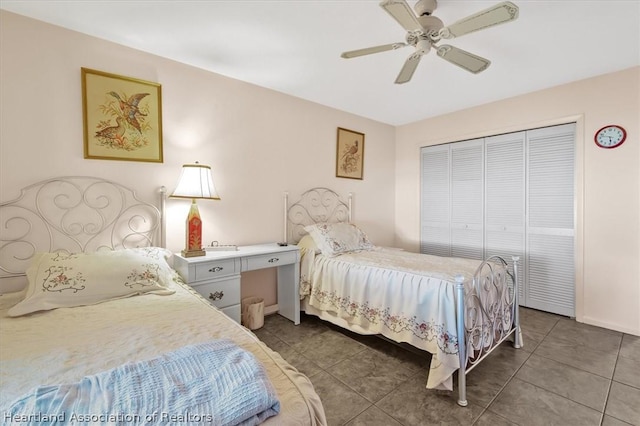 tiled bedroom with ceiling fan and a closet