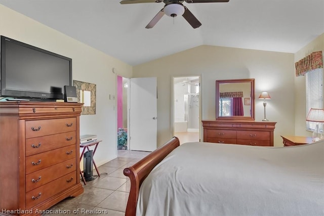 bedroom with light tile patterned floors, ensuite bathroom, ceiling fan, and lofted ceiling