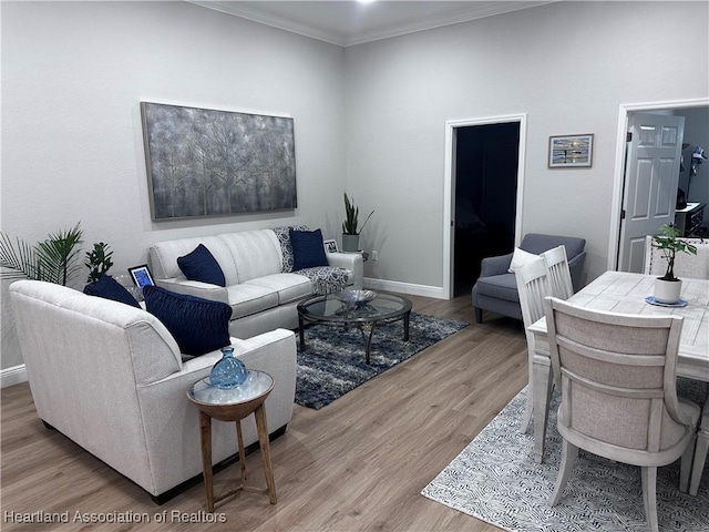 living room featuring light hardwood / wood-style floors and crown molding