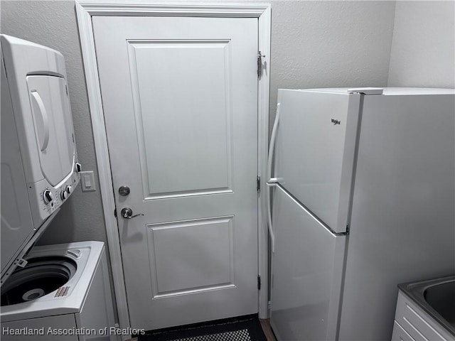 clothes washing area with stacked washer and dryer