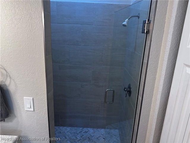 bathroom with a shower with door