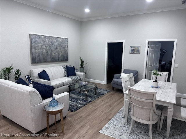 living room with light hardwood / wood-style flooring and crown molding