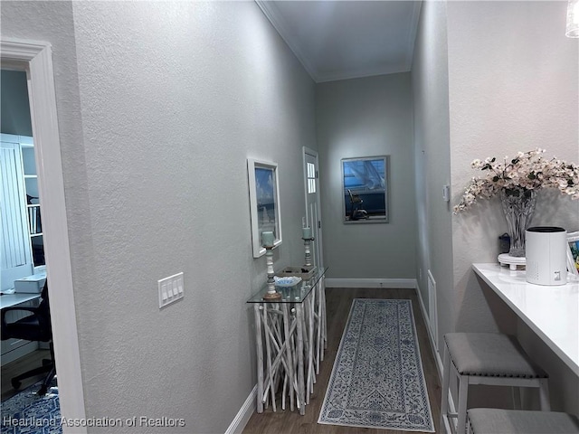 hall with dark hardwood / wood-style flooring and ornamental molding