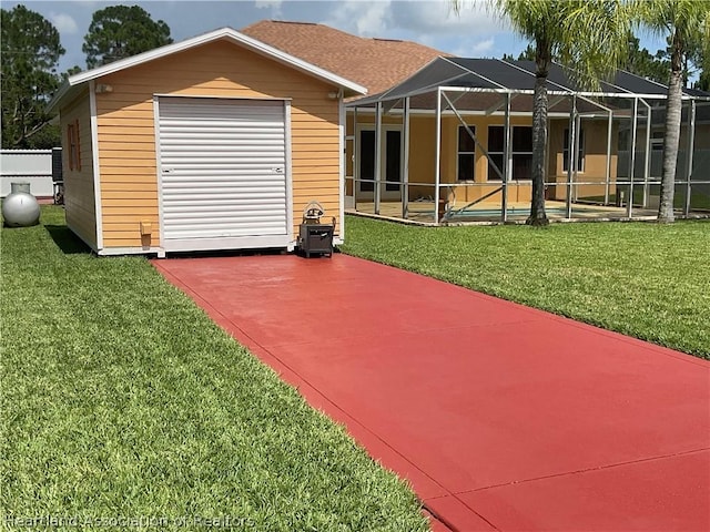 rear view of house featuring glass enclosure, a patio area, a yard, and a swimming pool