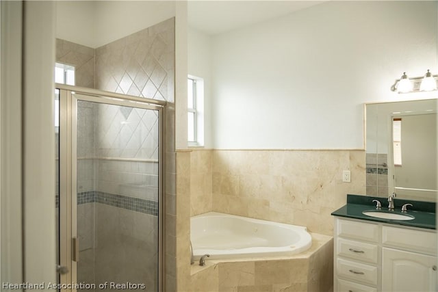 bathroom with vanity and independent shower and bath