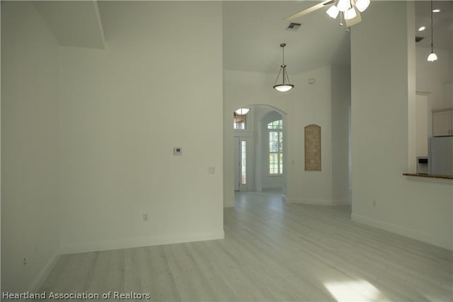 spare room featuring light wood-type flooring and ceiling fan