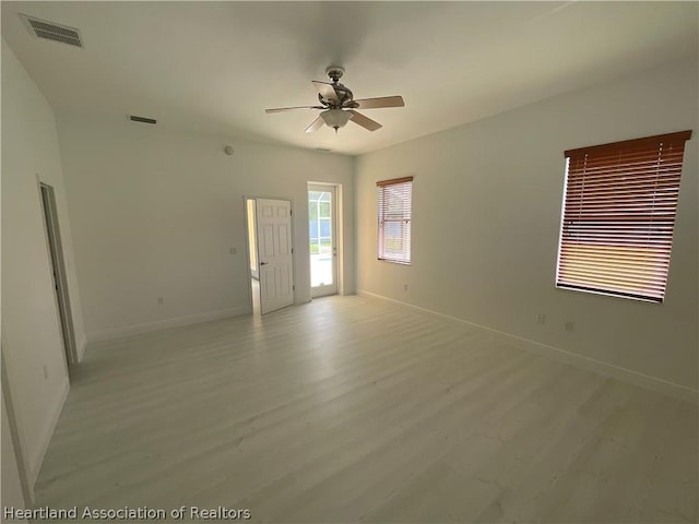 spare room featuring light hardwood / wood-style floors and ceiling fan