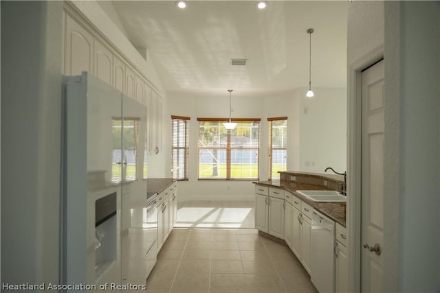 kitchen with white cabinetry, sink, pendant lighting, white appliances, and light tile patterned floors